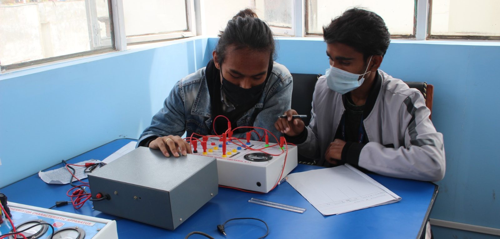 Students running an experiment in the electronics lab
